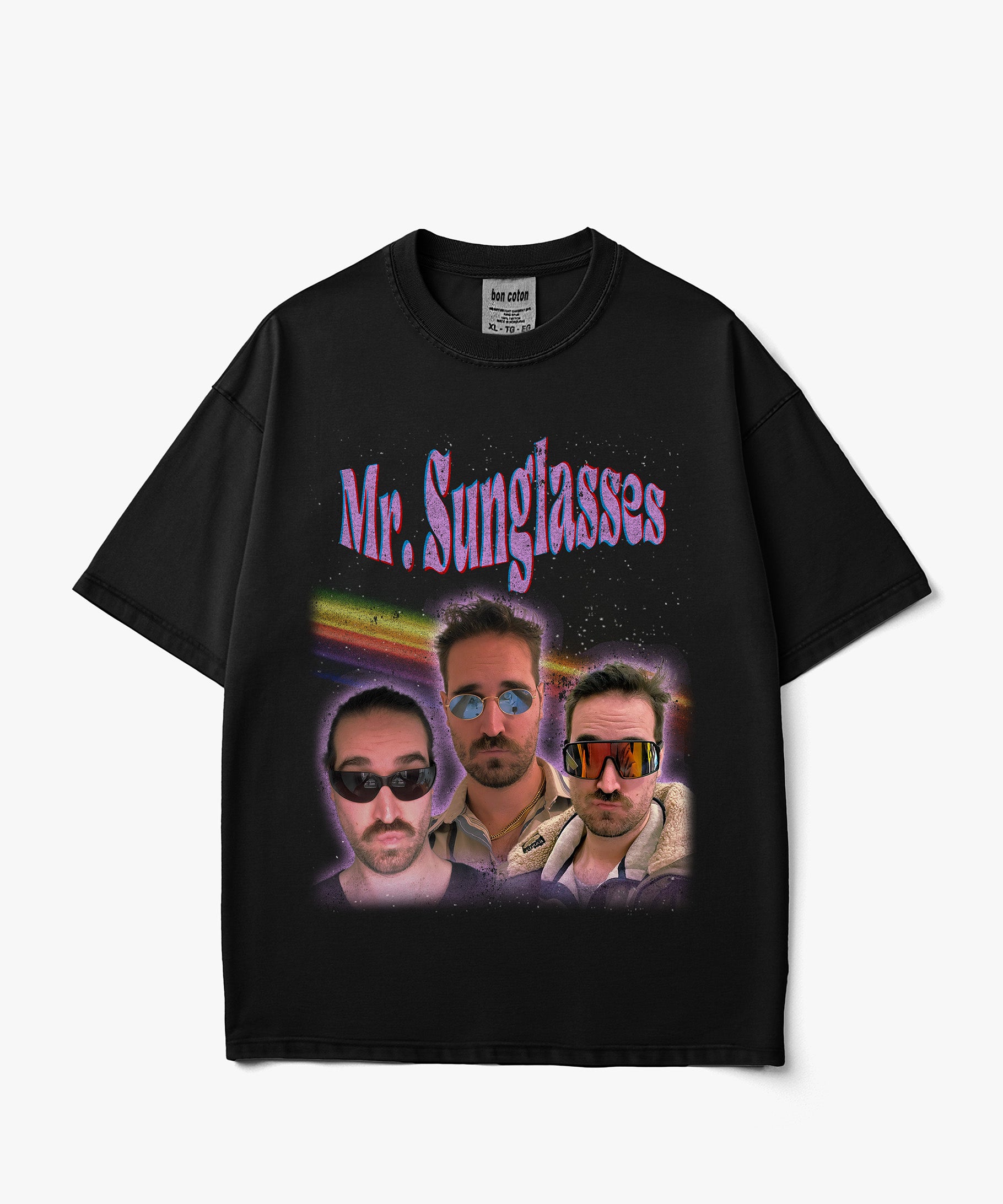 Image of A black short-sleeve graphic t-shirt featuring the text 'Mr. Sunglasses' in purple above a colorful collage of three men wearing sunglasses, displayed against a light gray background.